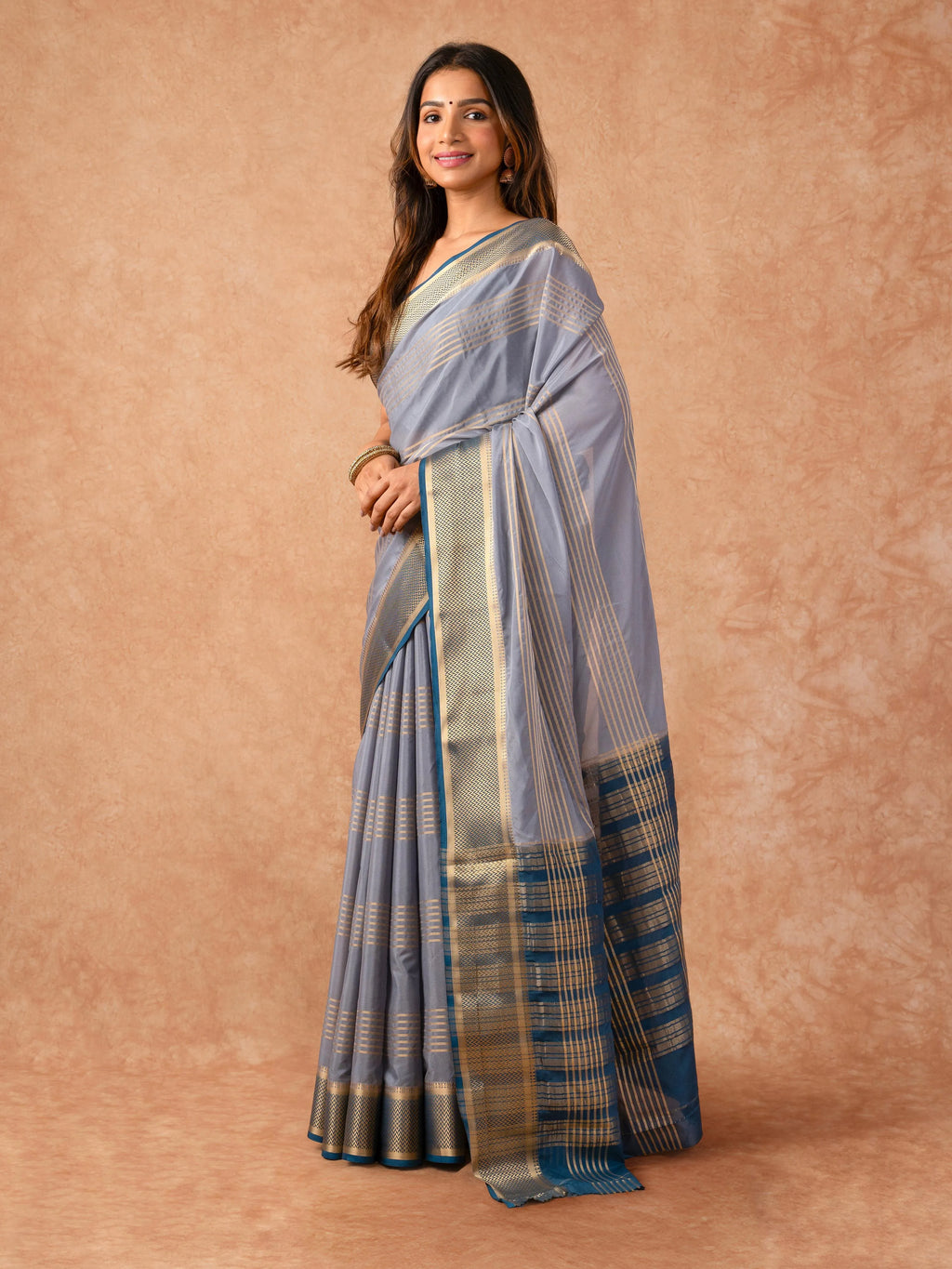 Woman wearing a Semi Crepe Silk Saree with soft drape and subtle shine, ideal for office, family gatherings, and festive occasions.