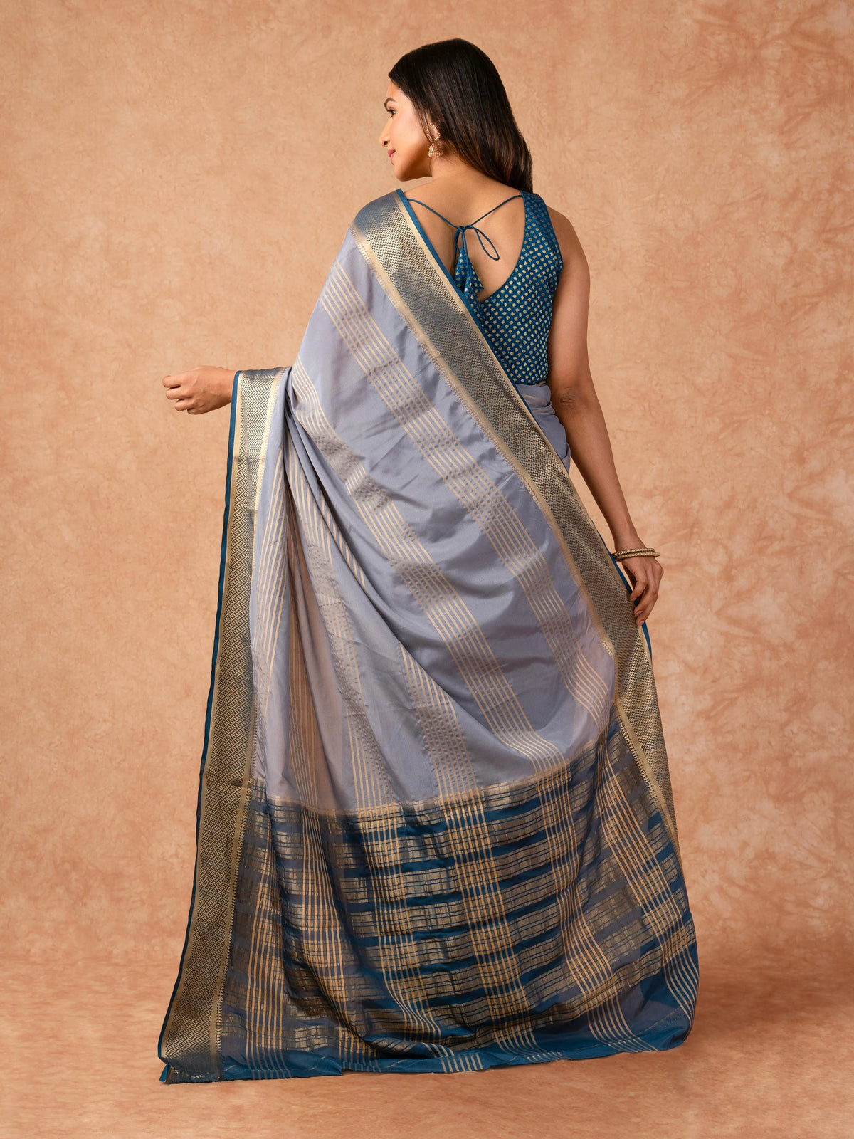 Woman wearing a Semi Crepe Silk Saree with soft drape and subtle shine, ideal for office, family gatherings, and festive occasions.