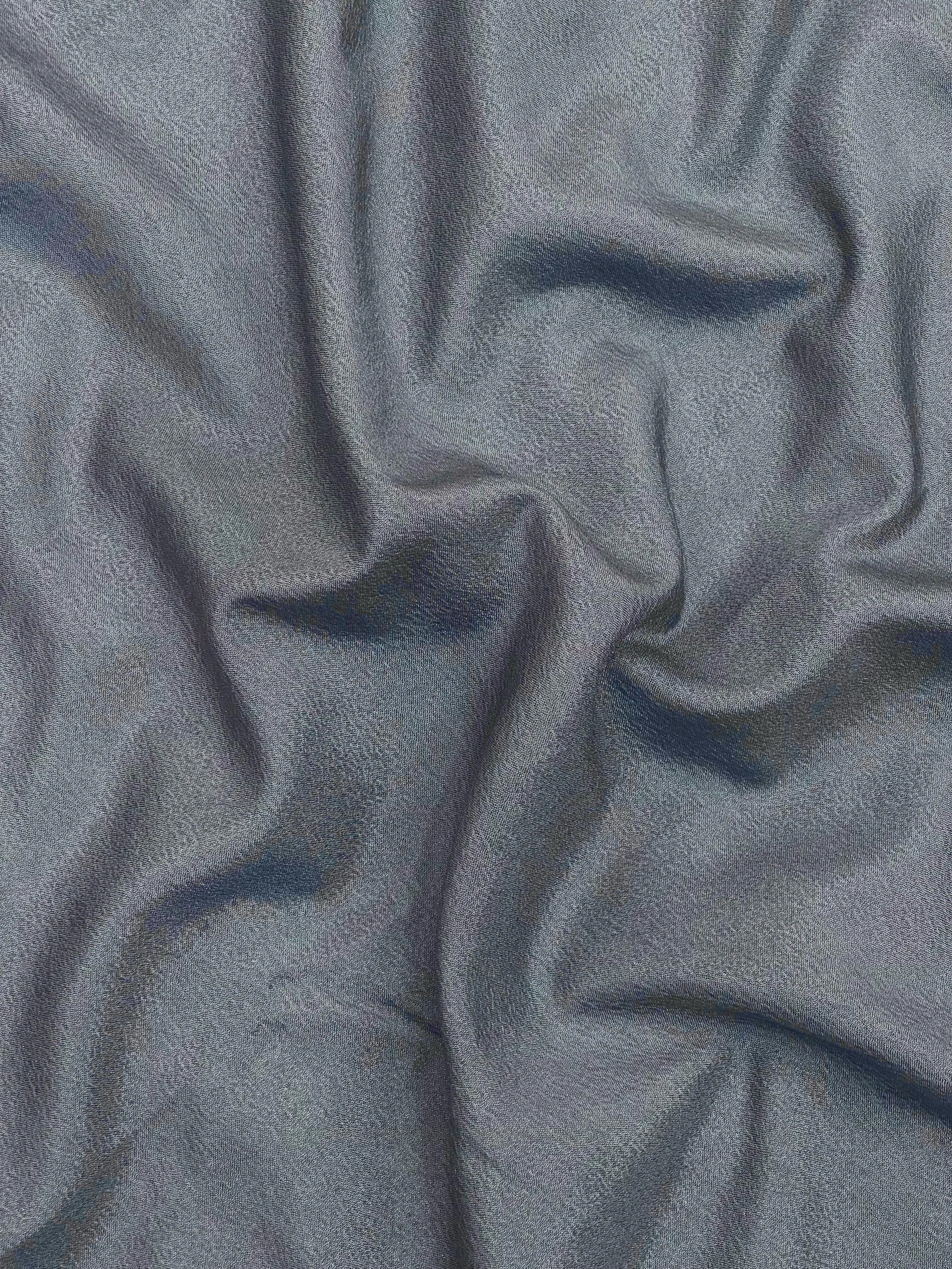 Woman draped in a Semi Crepe Silk Saree with soft texture and subtle shine, perfect for elegant office wear and festive occasions.