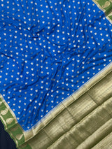 Woman wearing a Semi Khaddi Georgette Saree with soft fabric and zari highlights, ideal for festive and traditional occasions.