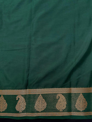 Woman wearing a Semi Khaddi Georgette Saree with soft fabric and zari highlights, ideal for festive and traditional occasions.