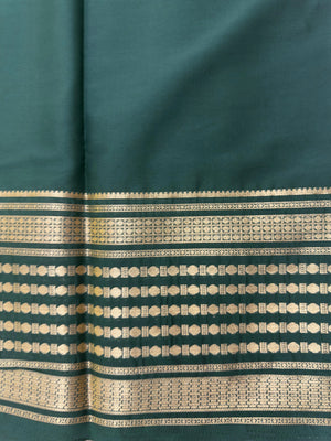 "Semi Mysore Silk Saree in a soft, breathable fabric with a smooth drape, perfect for daily wear. Subtle sheen and elegant design, ideal for both casual and formal occasions."