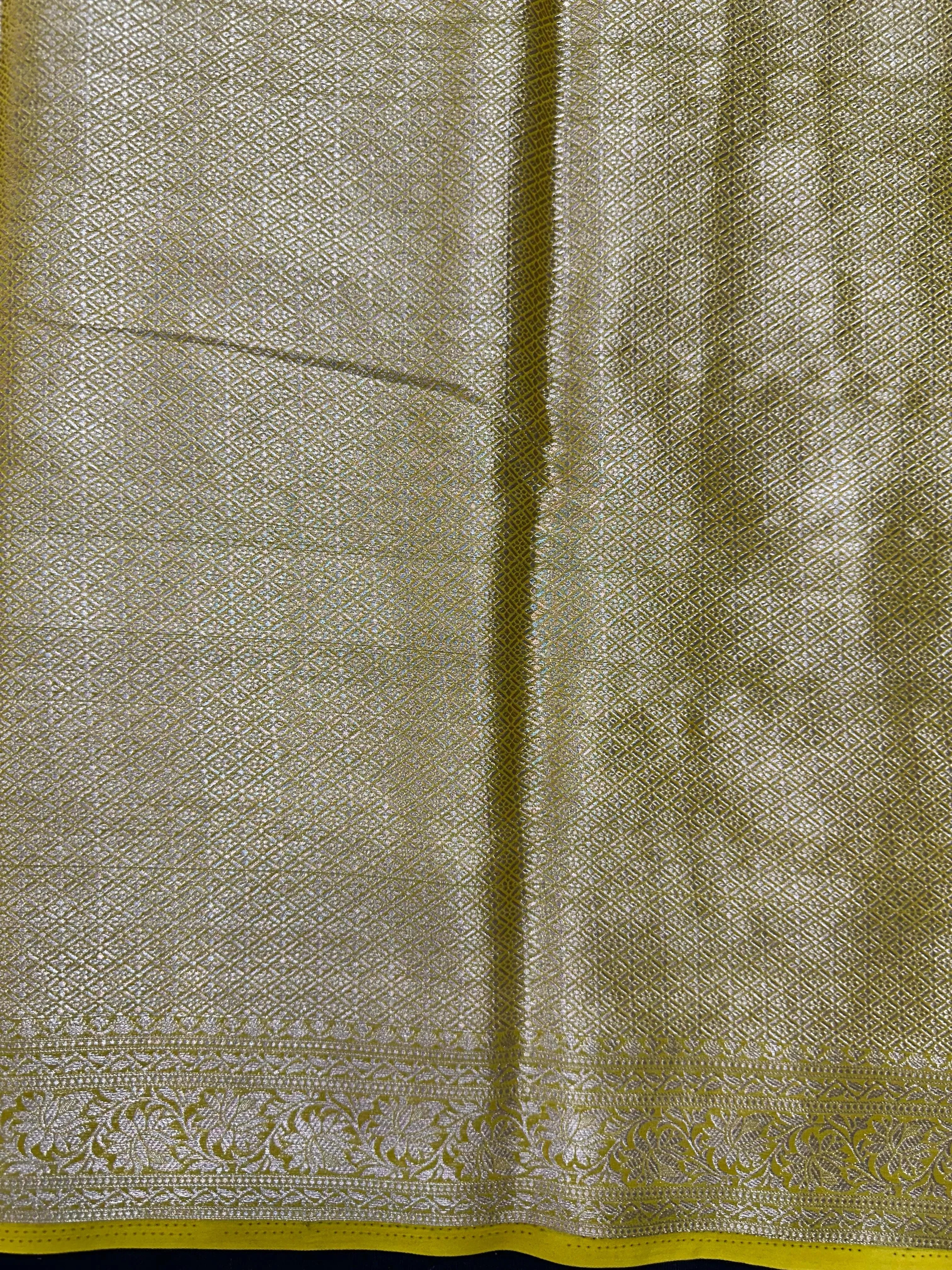 “Woman draped in a Semi Khaddi Georgette saree featuring intricate Banarasi motifs and a soft, flowy texture—perfect blend of tradition and lightness.”