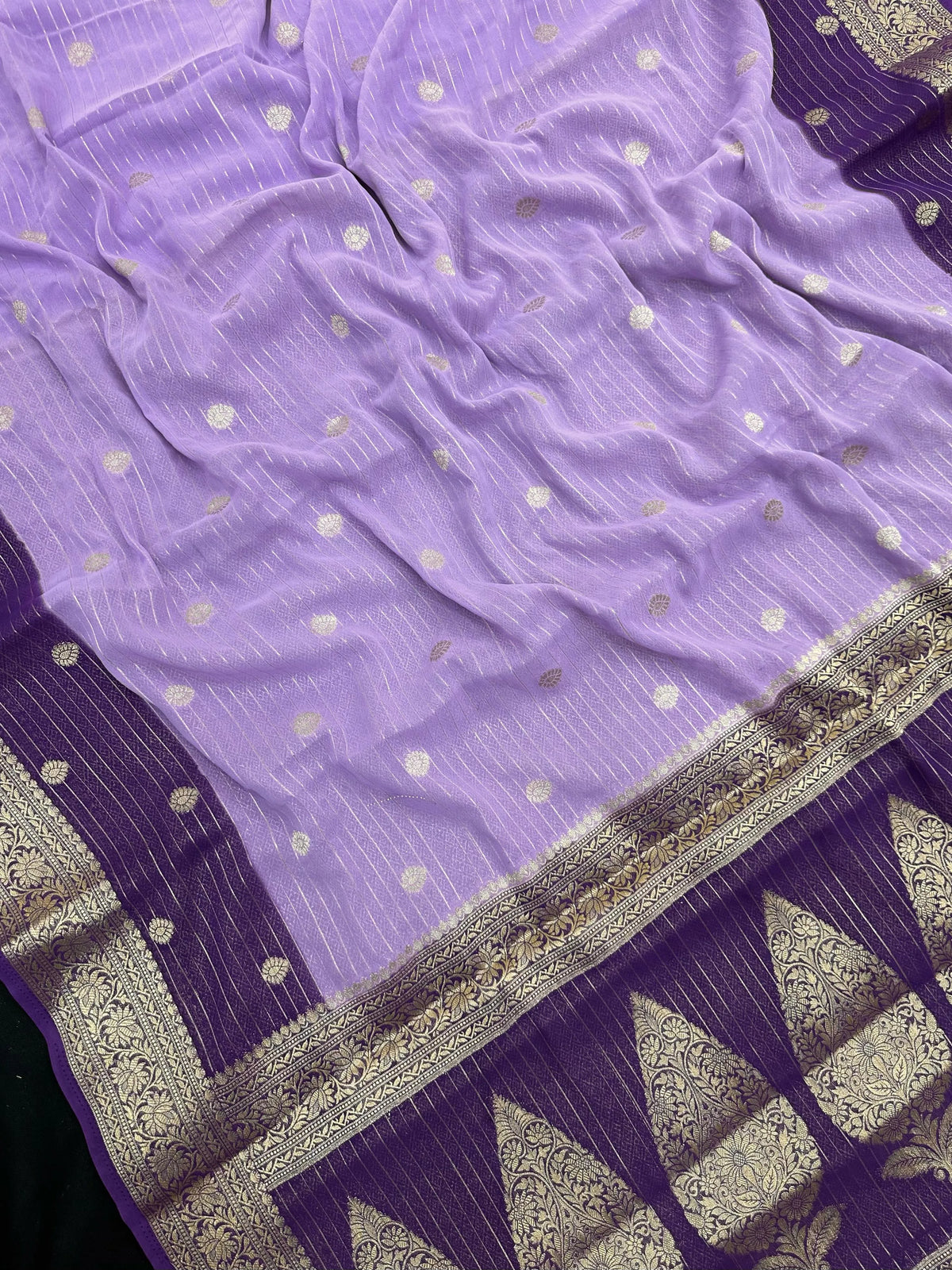 “Woman draped in a Semi Khaddi Georgette saree featuring intricate Banarasi motifs and a soft, flowy texture—perfect blend of tradition and lightness.”