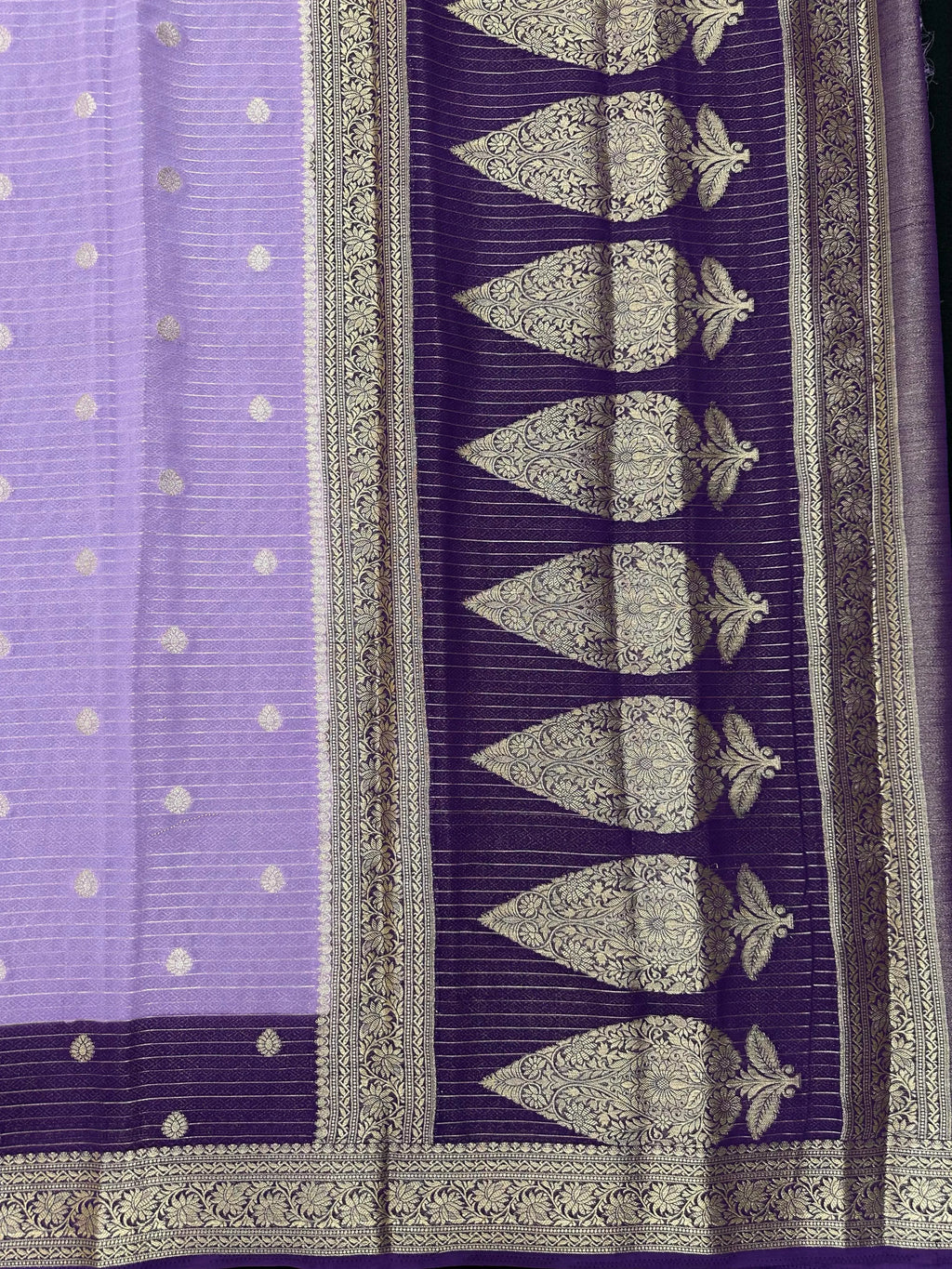 “Woman draped in a Semi Khaddi Georgette saree featuring intricate Banarasi motifs and a soft, flowy texture—perfect blend of tradition and lightness.”