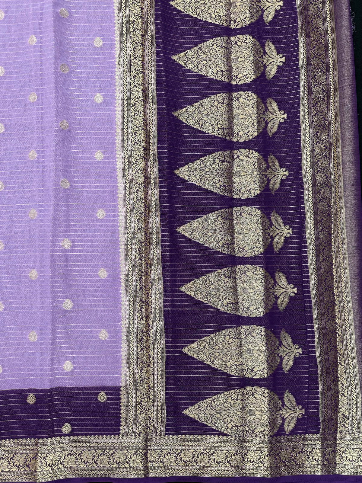 “Woman draped in a Semi Khaddi Georgette saree featuring intricate Banarasi motifs and a soft, flowy texture—perfect blend of tradition and lightness.”