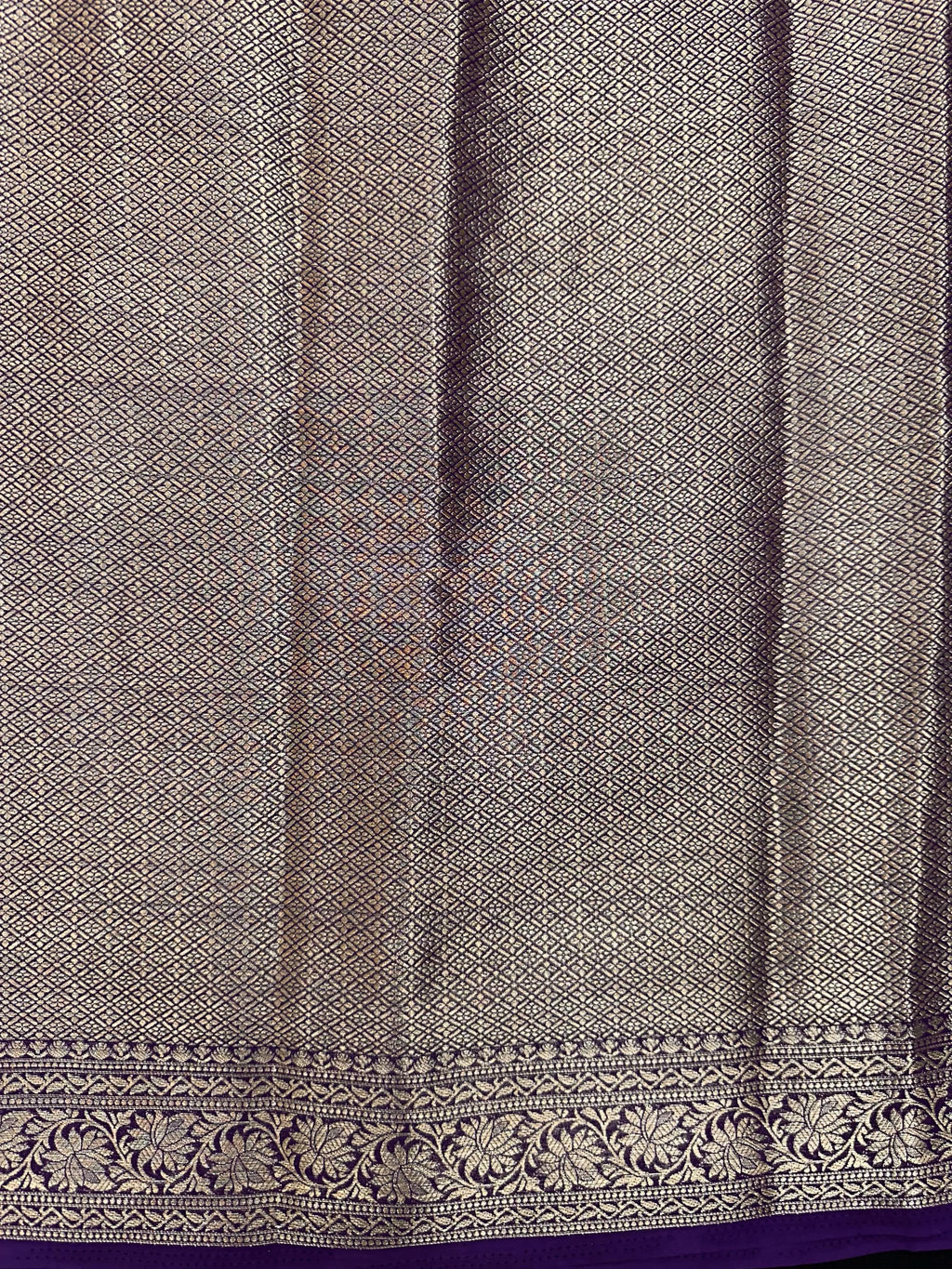 “Woman draped in a Semi Khaddi Georgette saree featuring intricate Banarasi motifs and a soft, flowy texture—perfect blend of tradition and lightness.”
