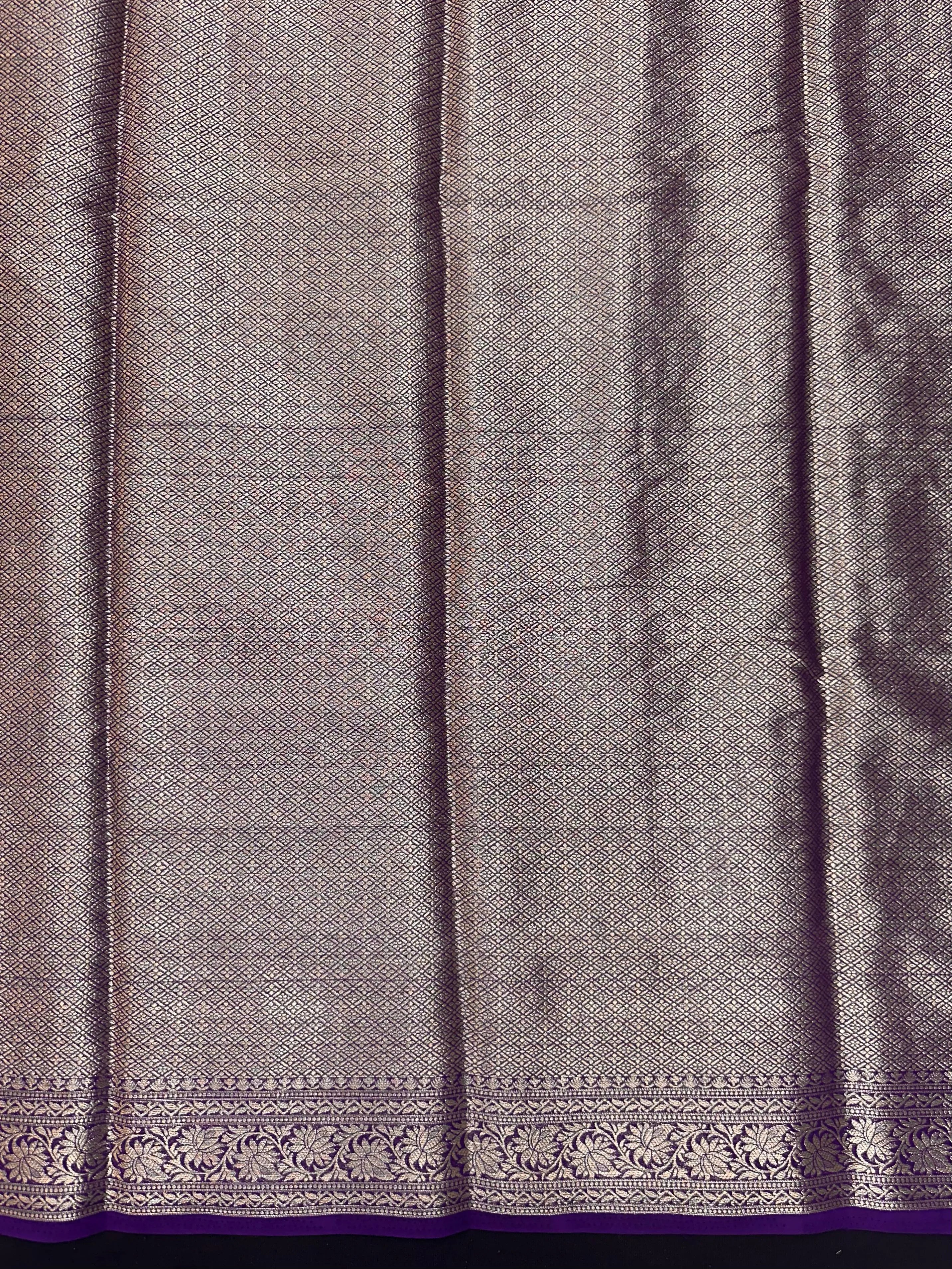 “Woman draped in a Semi Khaddi Georgette saree featuring intricate Banarasi motifs and a soft, flowy texture—perfect blend of tradition and lightness.”