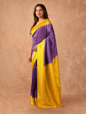 “Woman draped in a Semi Khaddi Georgette saree featuring intricate Banarasi motifs and a soft, flowy texture—perfect blend of tradition and lightness.”