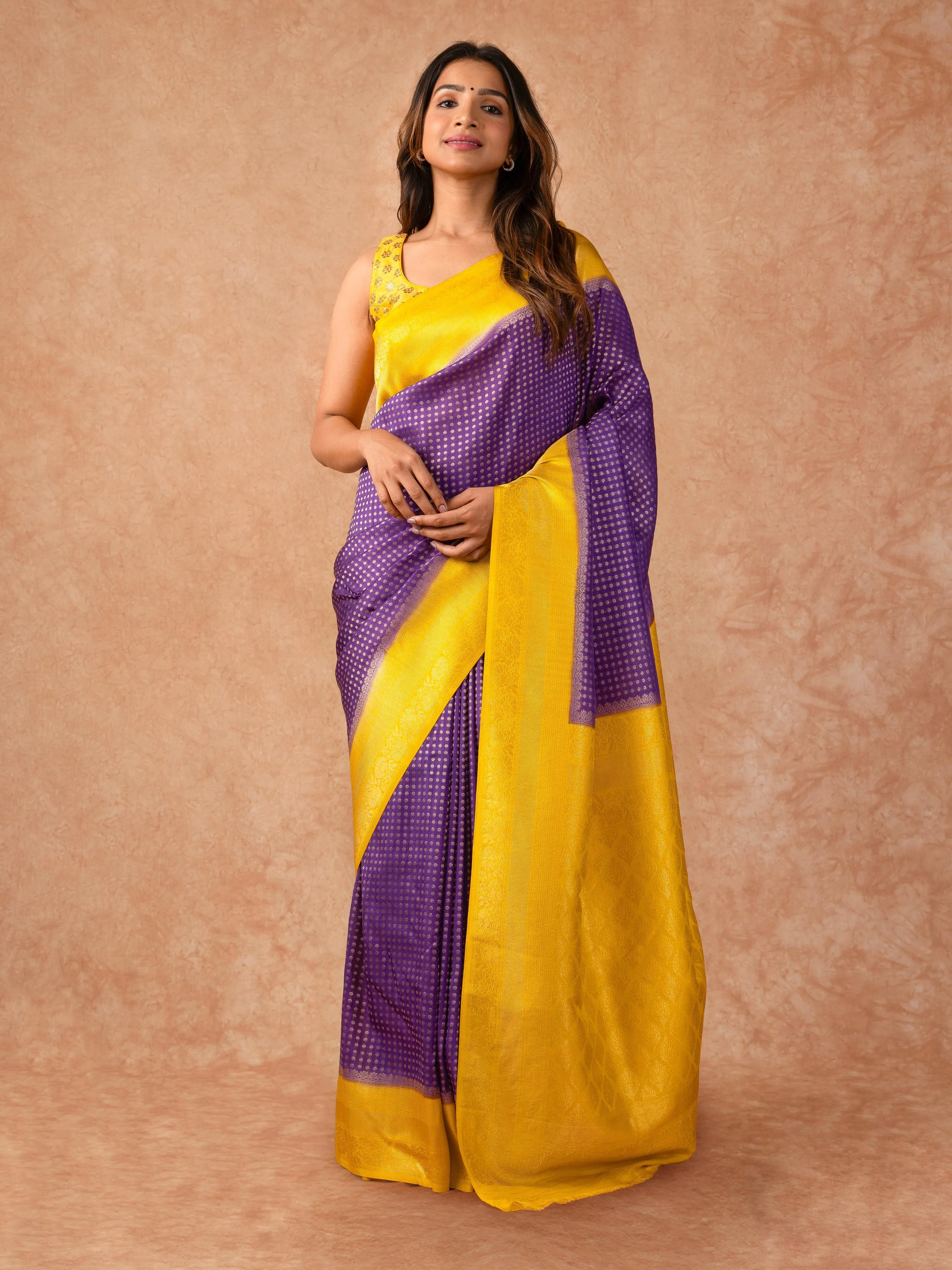“Woman draped in a Semi Khaddi Georgette saree featuring intricate Banarasi motifs and a soft, flowy texture—perfect blend of tradition and lightness.”