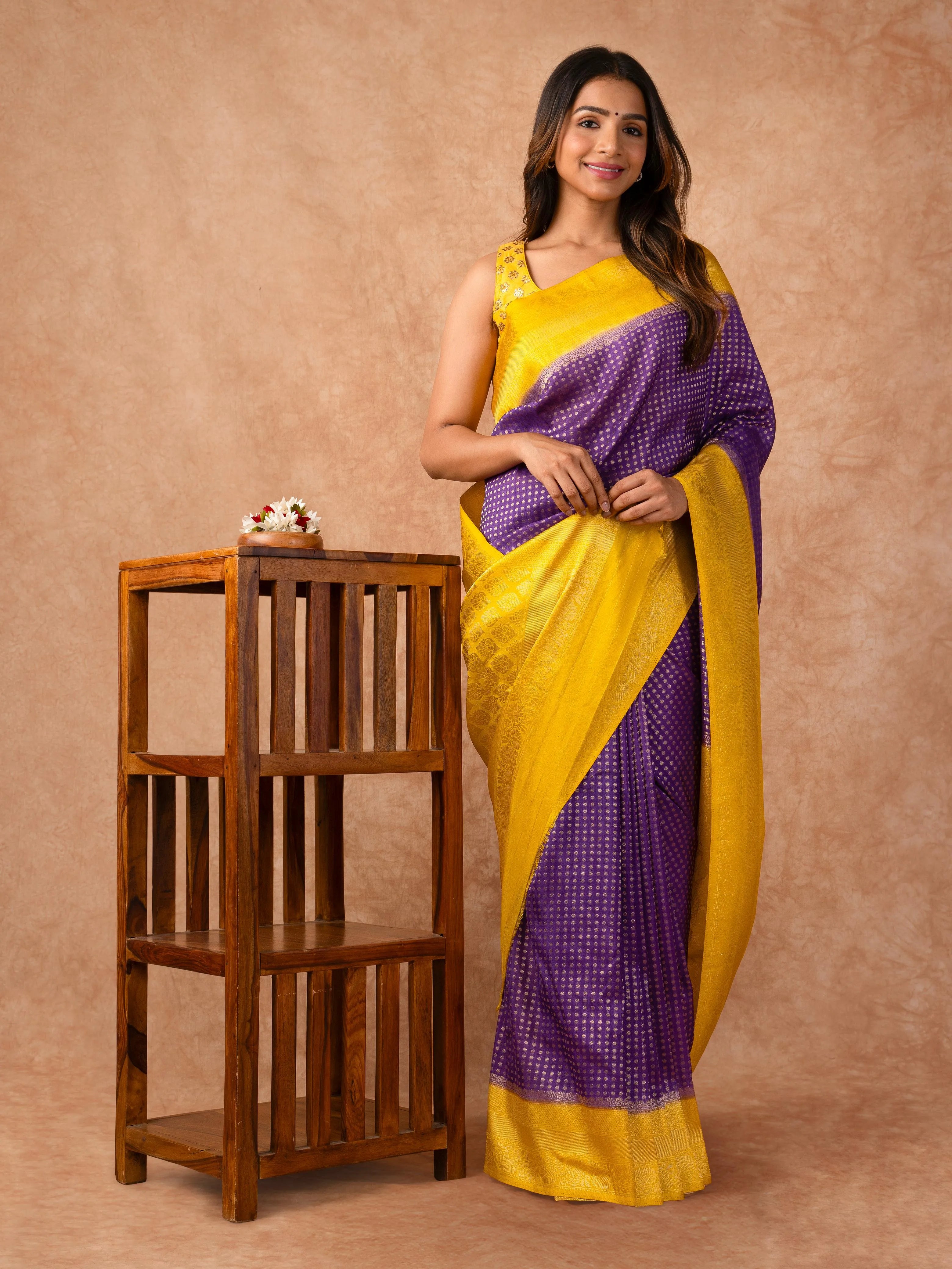 “Woman draped in a Semi Khaddi Georgette saree featuring intricate Banarasi motifs and a soft, flowy texture—perfect blend of tradition and lightness.”
