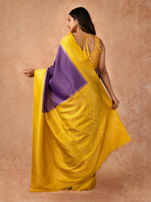 “Woman draped in a Semi Khaddi Georgette saree featuring intricate Banarasi motifs and a soft, flowy texture—perfect blend of tradition and lightness.”