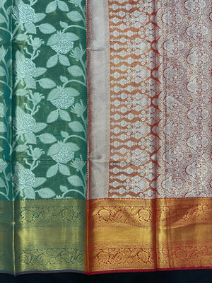 Model draped in a shimmering Tissue Banarasi Silk Saree with zari border, ideal for wedding and festive celebrations.