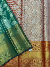 Model draped in a shimmering Tissue Banarasi Silk Saree with zari border, ideal for wedding and festive celebrations.