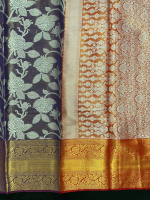 Model draped in a shimmering Tissue Banarasi Silk Saree with zari border, ideal for wedding and festive celebrations.