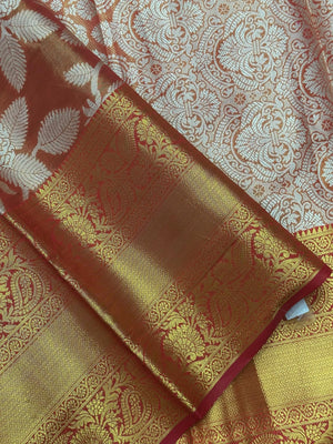 Model draped in a shimmering Tissue Banarasi Silk Saree with zari border, ideal for wedding and festive celebrations.