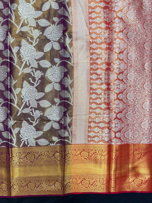 Model draped in a shimmering Tissue Banarasi Silk Saree with zari border, ideal for wedding and festive celebrations.