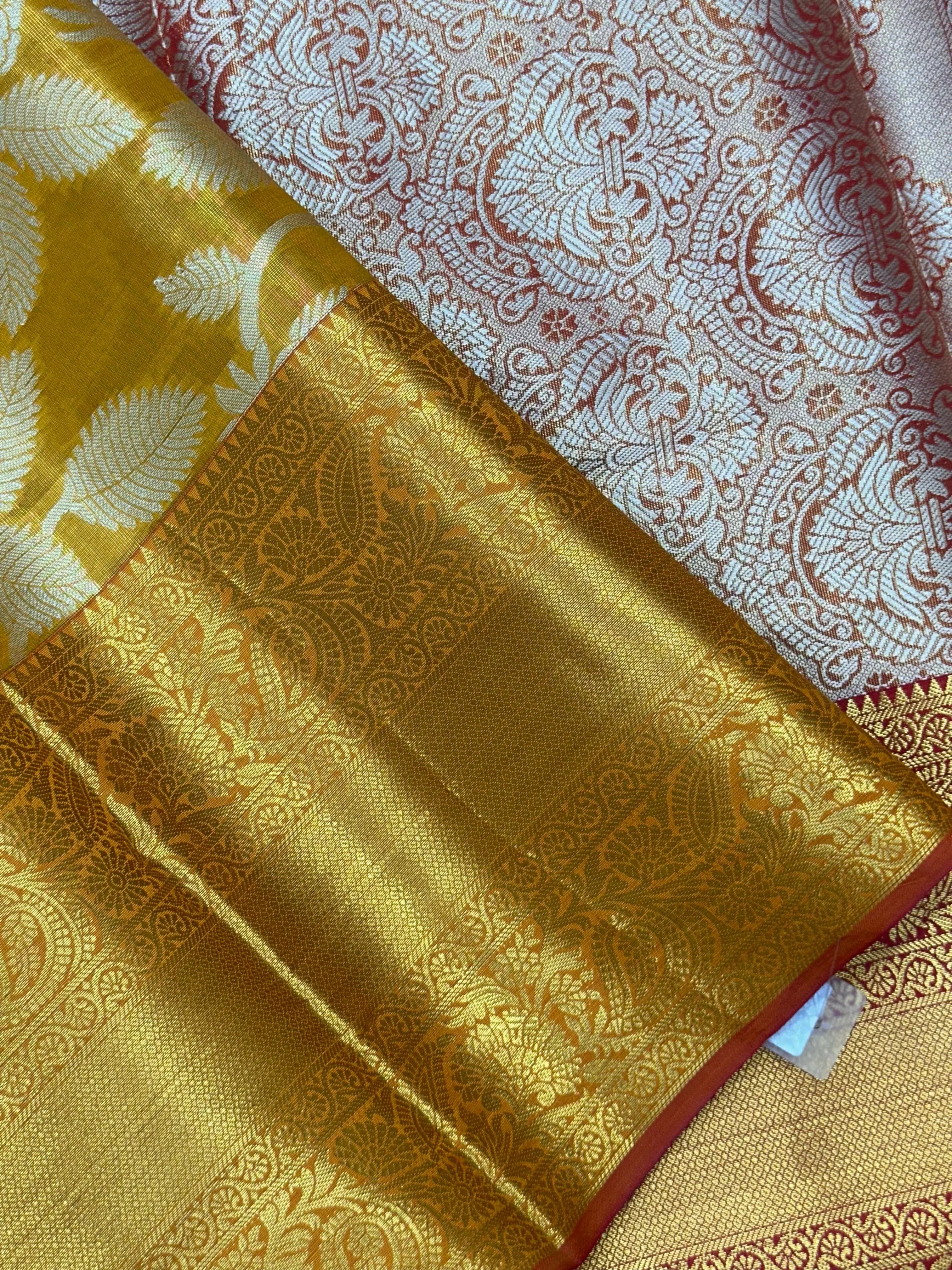 Model draped in a shimmering Tissue Banarasi Silk Saree with zari border, ideal for wedding and festive celebrations.