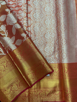 Model draped in a shimmering Tissue Banarasi Silk Saree with zari border, ideal for wedding and festive celebrations.