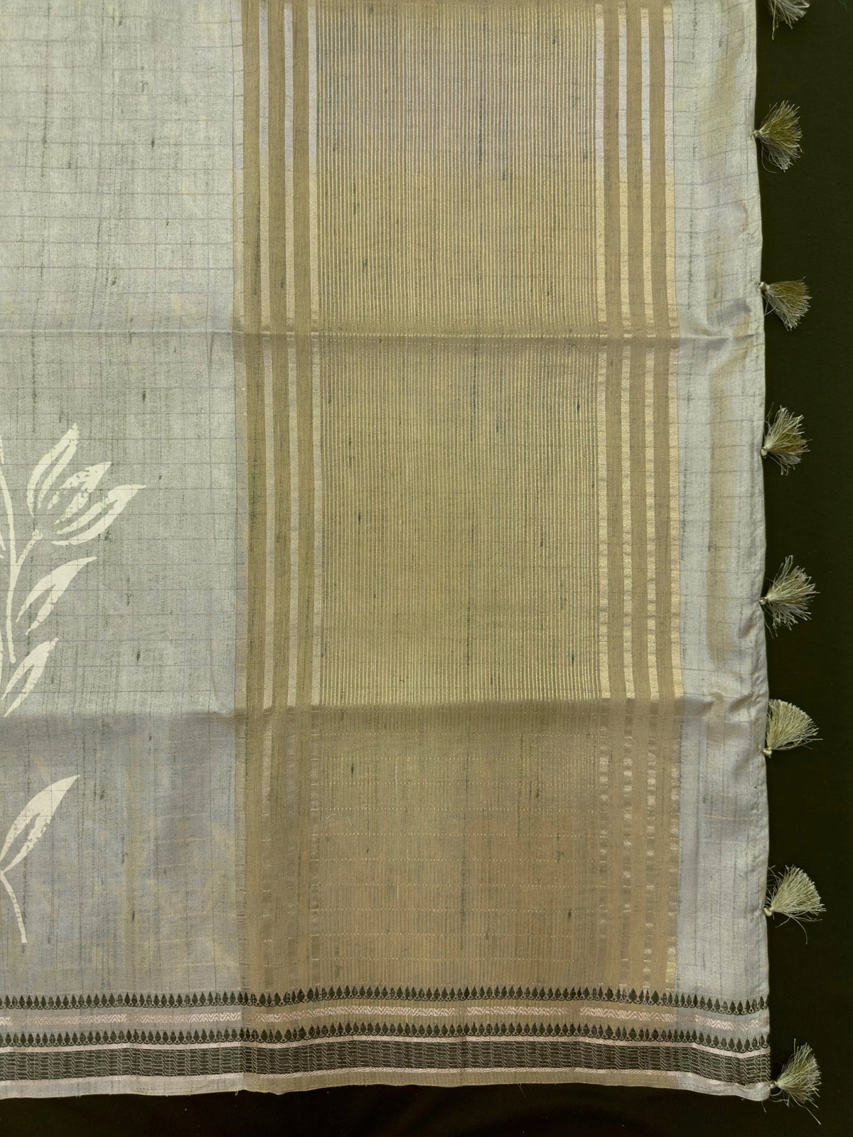 “Woman wearing a lightweight Tussar silk saree in earthy tones, featuring a soft natural sheen and subtle patterns—ideal for elegant daily wear.”