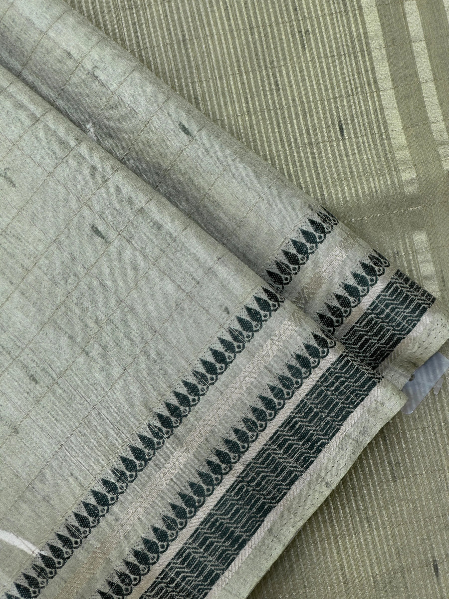 “Woman wearing a lightweight Tussar silk saree in earthy tones, featuring a soft natural sheen and subtle patterns—ideal for elegant daily wear.”